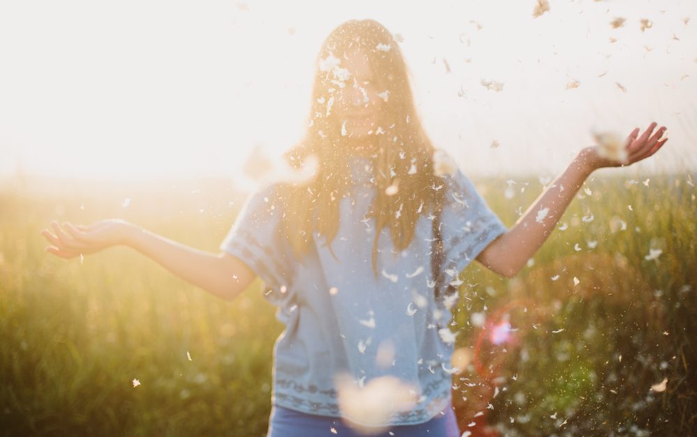 standish_shutterstock_265911278girlfeathersunset