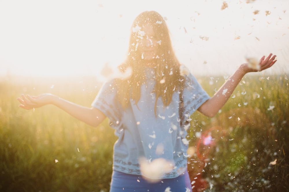 standish_shutterstock_265911278girlfeathersunset